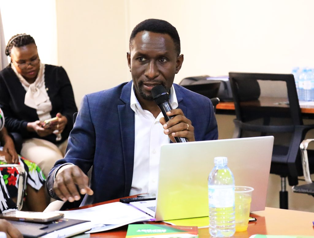 Andrew Mwesigwa, the representative from Makerere University Press presenting during the meeting
